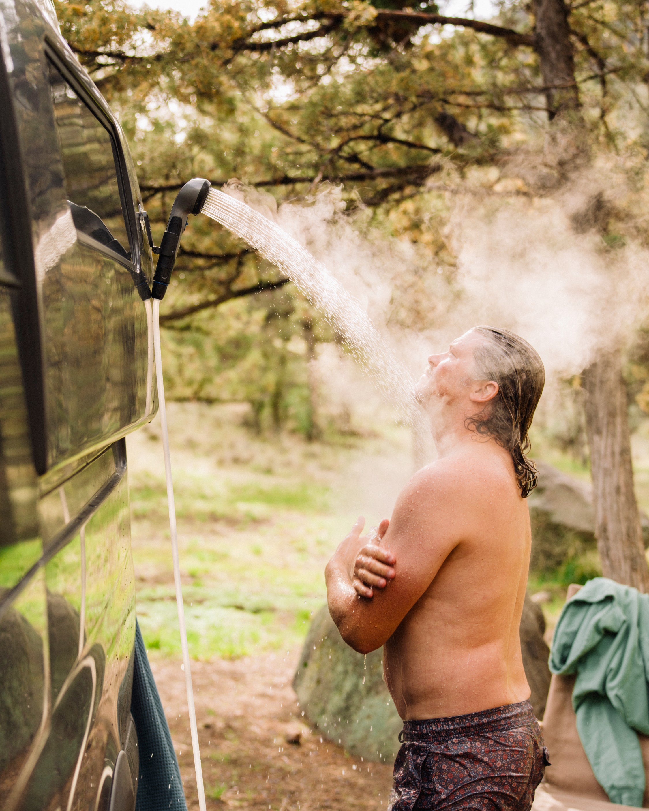 Kakadu Outback Shower portable hot water shower being used outdoors at overlanding campsite